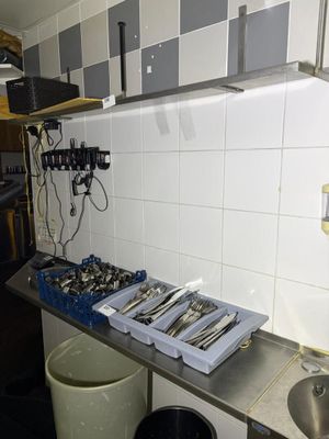 a picture of a kitchen with a lot of utensils on the counter