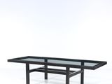 a black coffee table with a glass top on a white background
