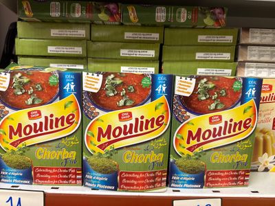 trois boîtes de Moulinine sur une étagère dans une épicerie