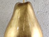 a gold pear that is sitting on a table