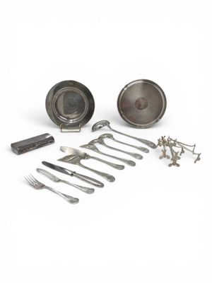 many different types of silverware on a white surface