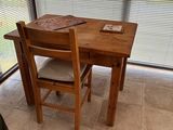 a small table with two chairs and a book on top of it
