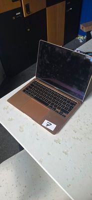 a laptop computer sitting on a desk in a room