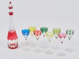 bottles and glasses are lined up in a row on a white surface
