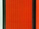 an open book with a red cover sitting on top of a white table