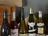 several bottles of wine are lined up on a shelf in a wine cellar
