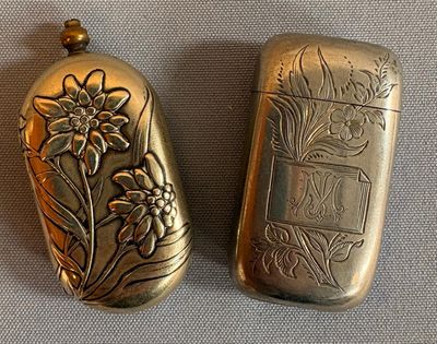 two small silver objects that are sitting on a table