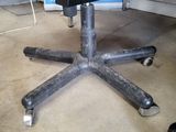 an image of a black office chair in a garage
