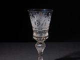 a glass that is on a table with a black background