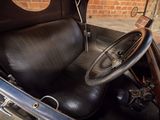 an old car with a leather seat and steering wheel
