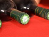 three bottles of wine sitting on a red table