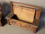 two wooden boxes with carvings on them sitting on a table