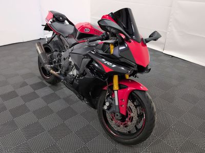 une moto garée dans une pièce au sol à carreaux et aux murs blancs