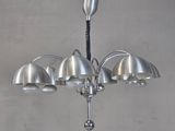 a metal chandelier with five lamps hanging from it