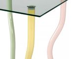 a glass table with three different colored sticks on it
