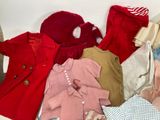 a lot of clothes that are sitting on a table