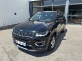 the jeep compass is parked in front of a building