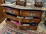 a dresser with a marble top in a room with a rug