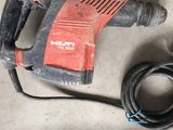 a drill and a cord on the floor next to a drill