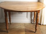 a small table with a wooden top on a hard wood floor