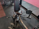 gym equipment in a gym with a cage in the background