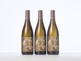 three bottles of wine sitting on top of a table next to each other