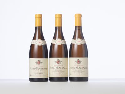 three bottles of wine sitting on top of a white table