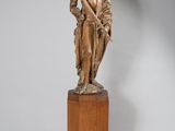 une image représentant une statue en bronze d'un homme tenant un chien dans ses bras