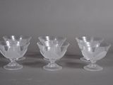 three clear glass goblets sitting on top of a table