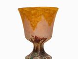 a glass cup that is sitting on a white surface