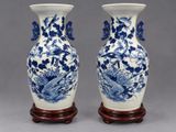 pair of blue and white vases with birds and flowers on them