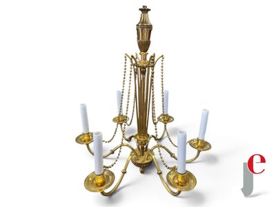 a gold chandelier with white candles on it