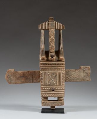 an image of a wooden sculpture of a man holding a knife