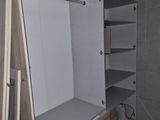 a very large closet with a built in shelf