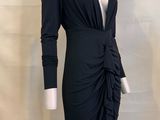 the mannequin is wearing a black dress with long sleeves