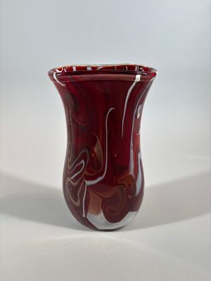 a red vase sitting on a table with a white background