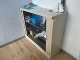 a small cabinet with a computer on top of it