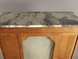 a small cabinet with a marble top on a table