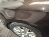 a picture of a brown car with a yellow sticker on it
