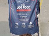 a bag of dry dog food sitting on the ground