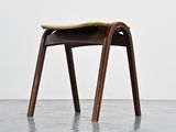 an image of a wooden chair with a yellow seat in a room