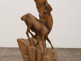sculpture of a horse and a dog on a rock
