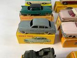 several toy cars are lined up in a row on a white surface