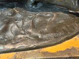 a bronze statue of a man riding a horse