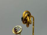a close up of a gold plated object with a flower on it