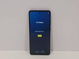 the back of a black samsung galaxy s9 with a blue screen and a yellow button