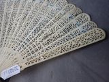 a fan with a tag on it sitting on a table