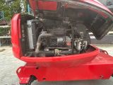 a red boat with a large engine in the back of it