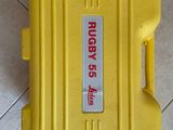 a yellow case sitting on the floor with a tag on it