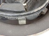 a close up of a metal object on a white surface